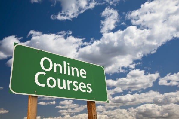 Online Courses Green Road Sign with Dramatic Sky and Clouds.