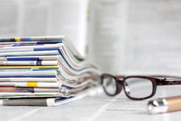 Newspapers and magazines blurred background concept