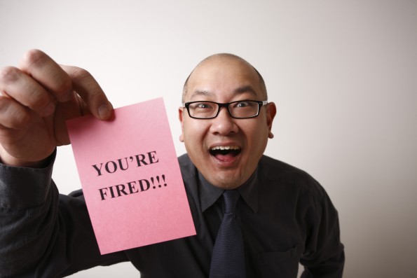 An unpleasant employer handing out pink slips.