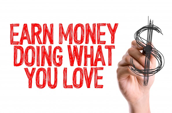 Hand with marker writing: Earn Money Doing What You Love