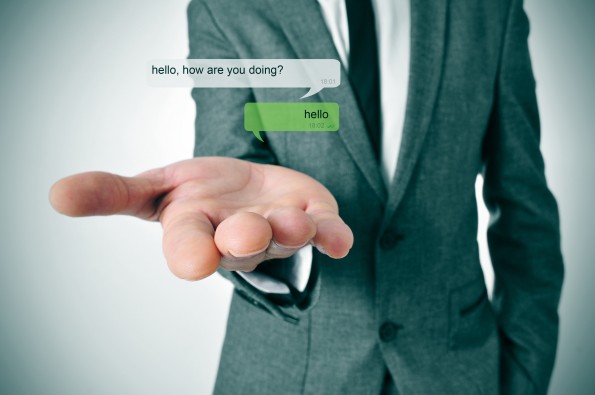 a man wearing a suit and a depiction of an instant messaging chat