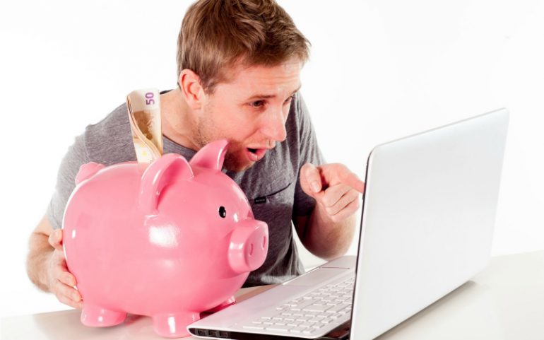 stockfoto spaarvarken laptop