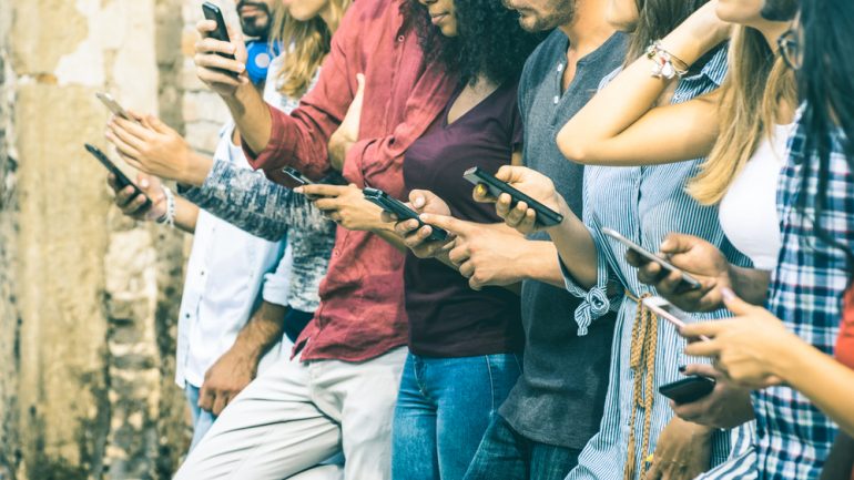 group of friends using smartphones