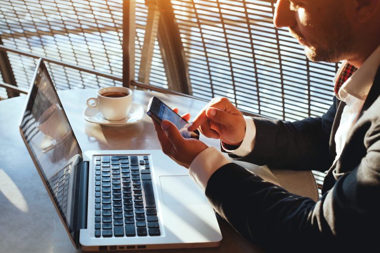 man-using-laptop-smartphone