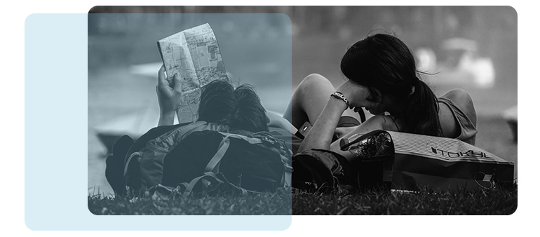 Afbeelding van twee personen die in het gras liggen en aan het lezen zijn.