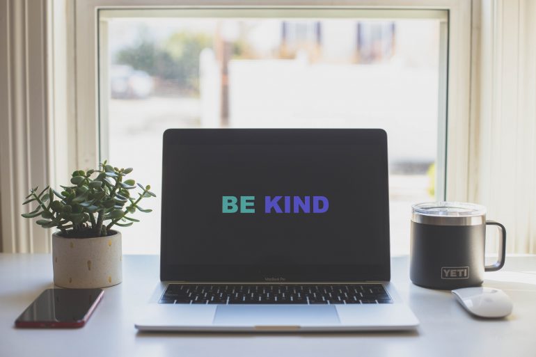 Tekst 'Be Kind' op een beeldscherm