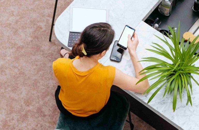 Een mevrouw die aan het thuiswerken is.