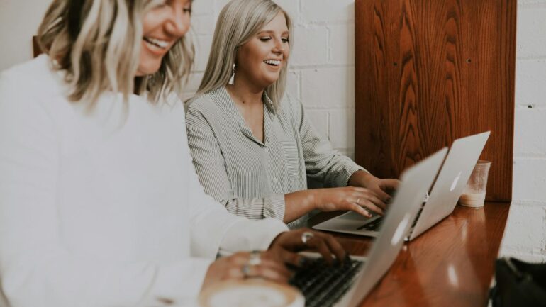 werkgeluk onder werknemers twee vrouwen op laptop